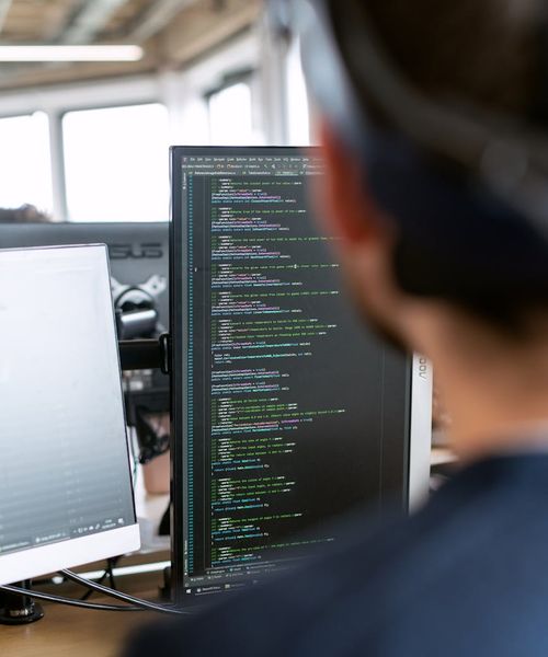 Male software developer programming at workstation